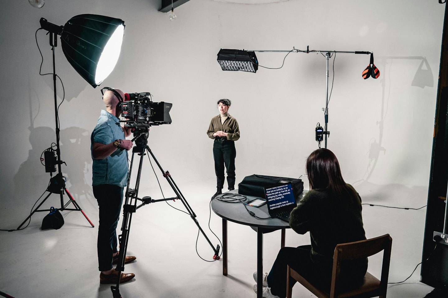 People filming a presentation with a teleprompter.